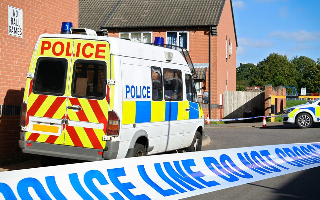 Crime scene cordon tape in front of police van