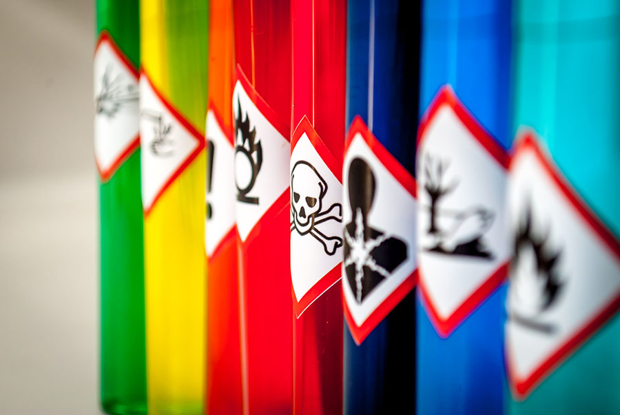 Various safety warning labels on canisters of hazardous materials