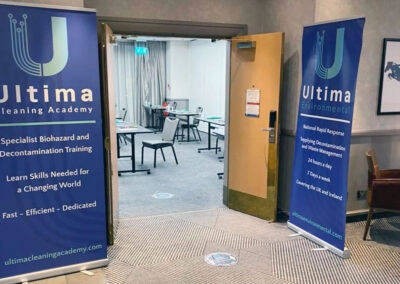 The entrance to a classroom is flagged by banners displaying the Ultima logo