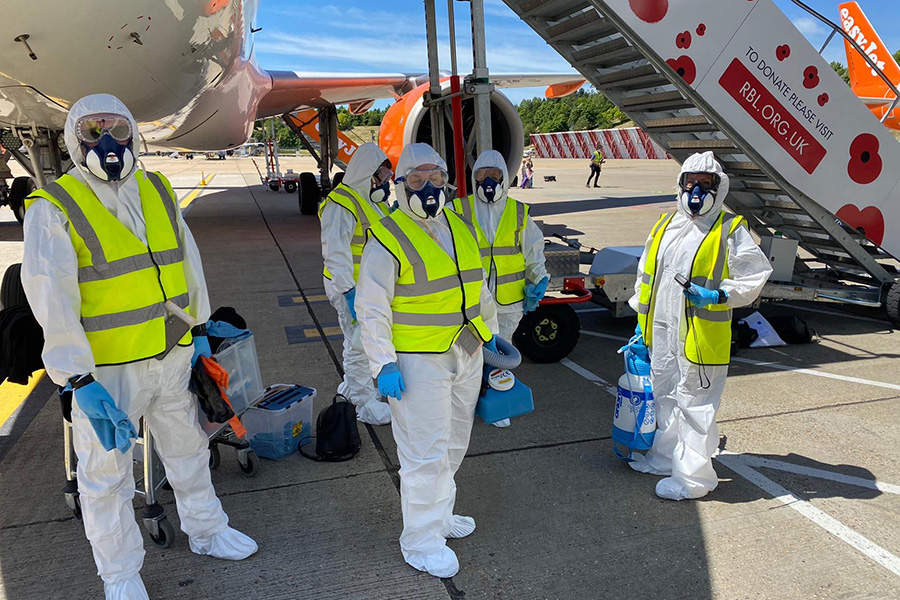 A group of specialist cleaners standing in front of an Aircraft